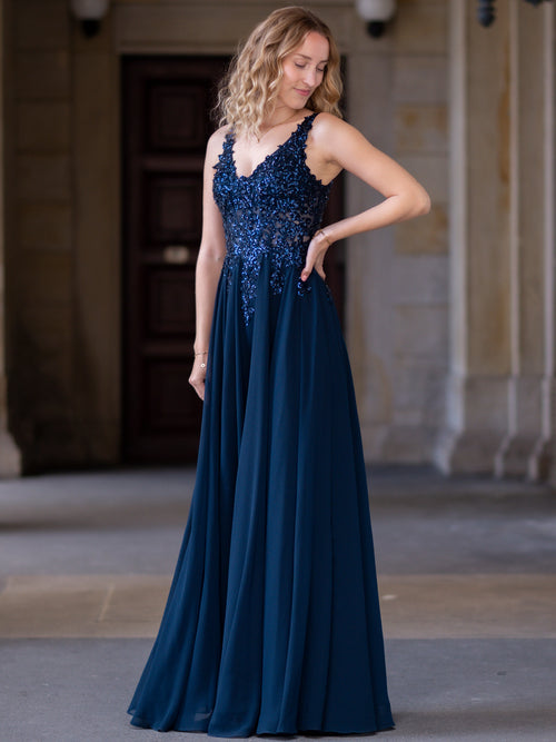 Elegantes Abendkleid in Dunkelblau mit Paillettenbesatz und V-Ausschnitt, perfekt für besondere Anlässe.